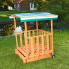 Children's wooden frame sandbox with veranda with protective roof and sunshade in green color
