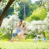 Round wooden children's seating set with parasol, white garden bench and picnic table