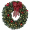 Világító karácsonyi ajtókoszorú 60 cm-es ünnepi műfenyő koszorú 50 LED-del, piros bogyókkal, tobozokkal és masnival