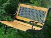 Garden bench with wrought iron lattice backrest and wooden seat with cast iron frame