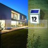 Solar lamp illuminating house number in small size. Outdoor design, flat shape, stainless steel, 2 LED lights. Waterproof and bird-proof design