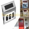 Solar lamp illuminating house number in small size. Outdoor design, flat shape, stainless steel, 2 LED lights. Waterproof and bird-proof design
